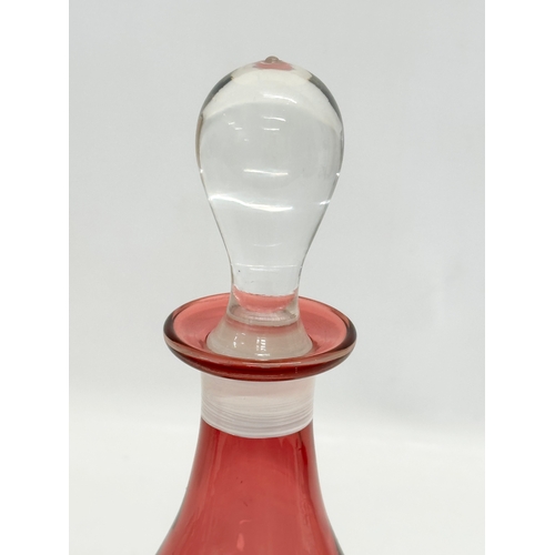 78 - 2 pieces of 19th Century style Mary Gregory cranberry glass. A decanter 30cm. Vase 29cm