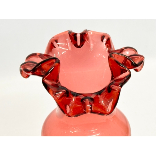 78 - 2 pieces of 19th Century style Mary Gregory cranberry glass. A decanter 30cm. Vase 29cm