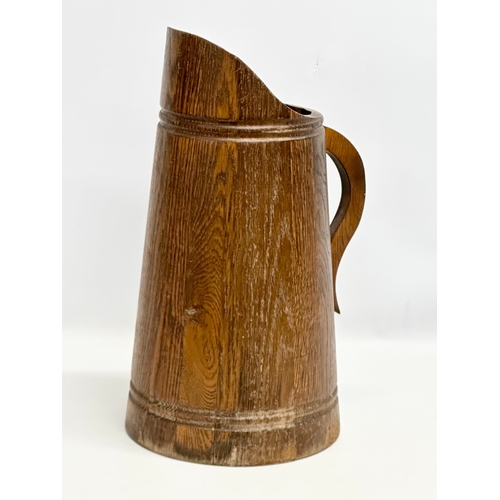 403 - A vintage oak planter, in the form of a jug. 26x48.5cm