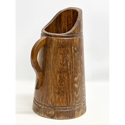 403 - A vintage oak planter, in the form of a jug. 26x48.5cm