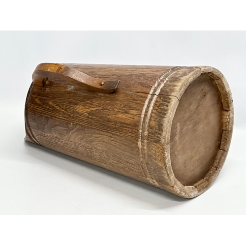 403 - A vintage oak planter, in the form of a jug. 26x48.5cm