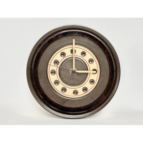 407 - A Mid Century glazed stoneware wall clock by Jersey Pottery. 24cm.