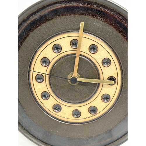 407 - A Mid Century glazed stoneware wall clock by Jersey Pottery. 24cm.