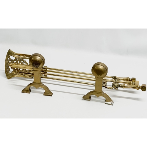 408 - A brass companion set. Fire andirons and tools.