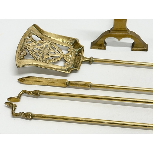 408 - A brass companion set. Fire andirons and tools.