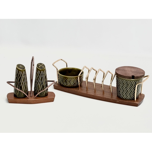 186 - A Mid Century teak toast rack, with matching salt and pepper shakers. Wyncraft and Lord Nelson. 28cm... 