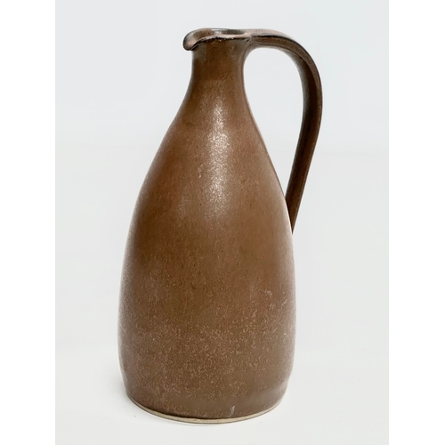 415 - Susan Cupitt. A glazed stoneware, studio pottery jug by Susan Cupitt (b.1936) 18cm