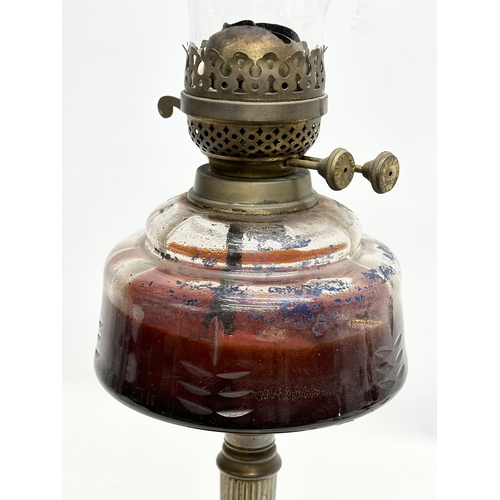 127 - A 19th Century Victorian double burner oil lamp. With reeded brass column and glass bowl. 66cm