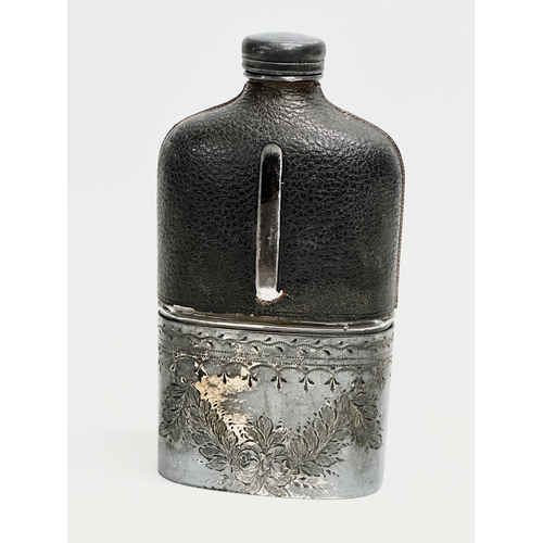 409 - A Late 19th Century Victorian silver plated and leather bound hip flask. 16cm