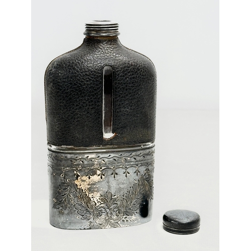 409 - A Late 19th Century Victorian silver plated and leather bound hip flask. 16cm