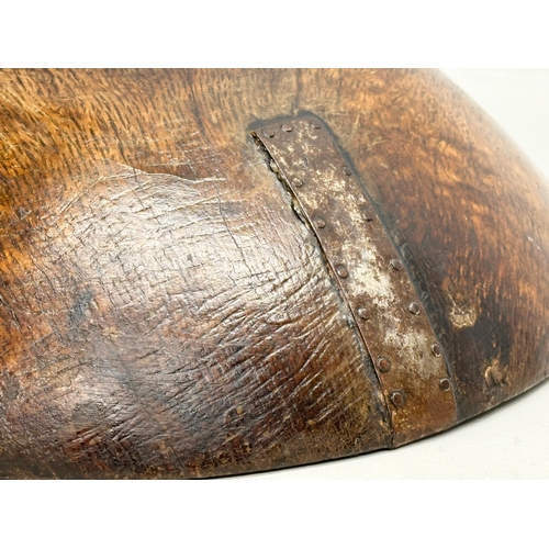 51 - A Late 18th/Early 19th Century George III oak bowl. With hand forged iron repair. Circa 1760-1810. 3... 