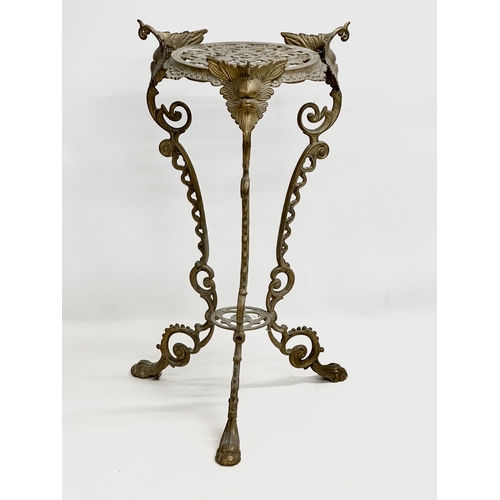 420 - A vintage brass plant stand. With mythical creatures and paw feet. 35x35x57cm