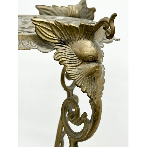 420 - A vintage brass plant stand. With mythical creatures and paw feet. 35x35x57cm