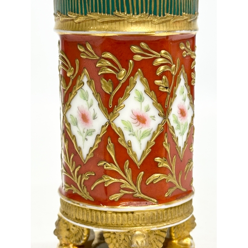 108 - Paris Porcelain. A 19th Century hand painted vase with embossed gilding, raised on 3 winged lion paw... 