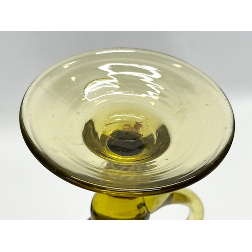 134 - A Mid 20th Century French amber glass candlestick by Biot. 11x14.5cm.