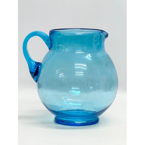 109 - A large Early 20th Century turquoise glass jug. Circa 1930. 25x22x25cm