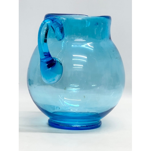 109 - A large Early 20th Century turquoise glass jug. Circa 1930. 25x22x25cm