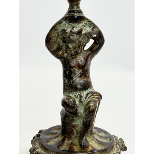 53 - A pair of Early 19th Century iron cherub candlesticks. 20cm