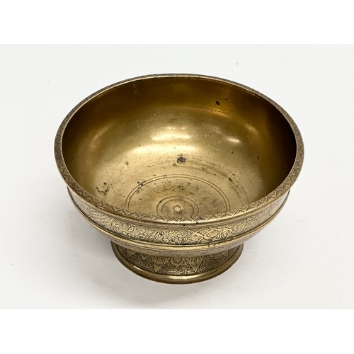 64 - An Early/Mid 19th Century Indian engraved brass footed bowl. 16x8.5cm.