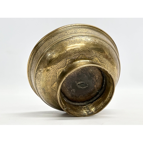 64 - An Early/Mid 19th Century Indian engraved brass footed bowl. 16x8.5cm.