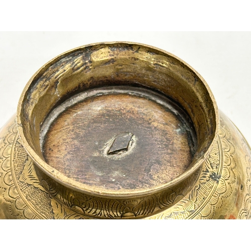 64 - An Early/Mid 19th Century Indian engraved brass footed bowl. 16x8.5cm.