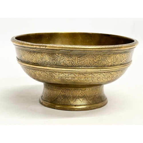 64 - An Early/Mid 19th Century Indian engraved brass footed bowl. 16x8.5cm.