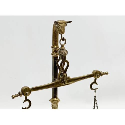 32 - An Early 20th Century brass weight scales. 22x35cm.