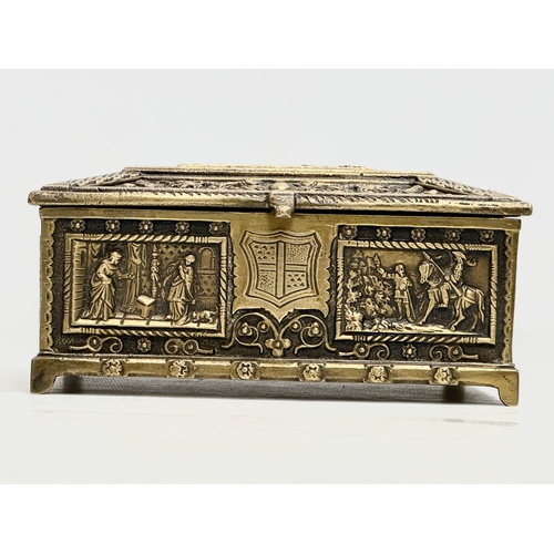 54 - A Late 19th/Early 20th Century brass moulded cigar box, with medieval scenes. 17x17x8cm.