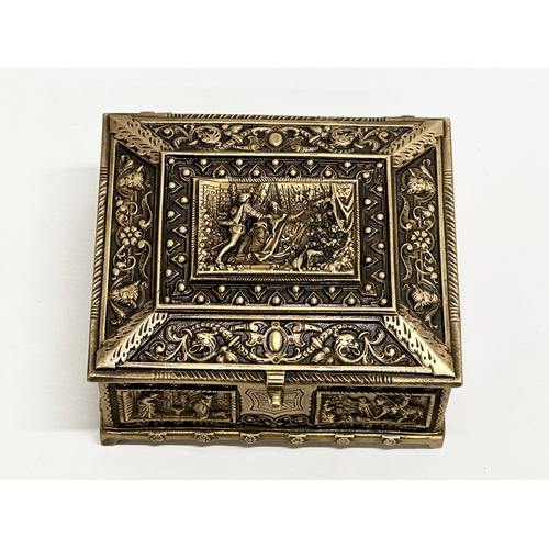 54 - A Late 19th/Early 20th Century brass moulded cigar box, with medieval scenes. 17x17x8cm.