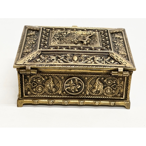 54 - A Late 19th/Early 20th Century brass moulded cigar box, with medieval scenes. 17x17x8cm.