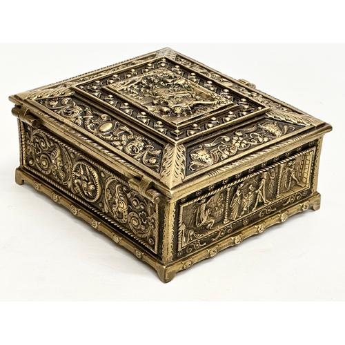 54 - A Late 19th/Early 20th Century brass moulded cigar box, with medieval scenes. 17x17x8cm.