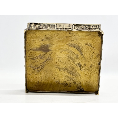 54 - A Late 19th/Early 20th Century brass moulded cigar box, with medieval scenes. 17x17x8cm.