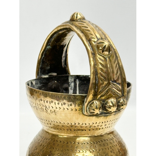 160 - An Early 20th Century Indian brass holy water vessel. 23cm.