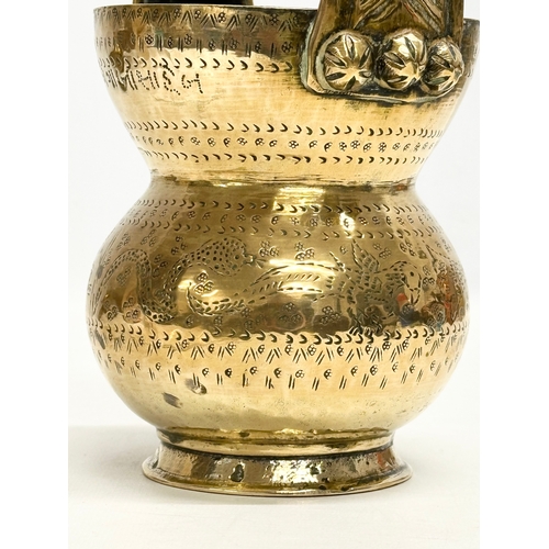 160 - An Early 20th Century Indian brass holy water vessel. 23cm.