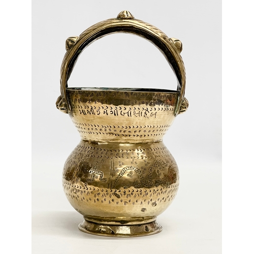 160 - An Early 20th Century Indian brass holy water vessel. 23cm.