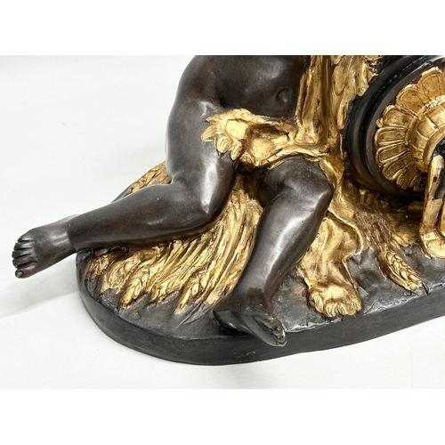 19 - A large signed Late 19th/Early 20th Century bronze sitting cherubs. Holding a gilded urn with rosett... 