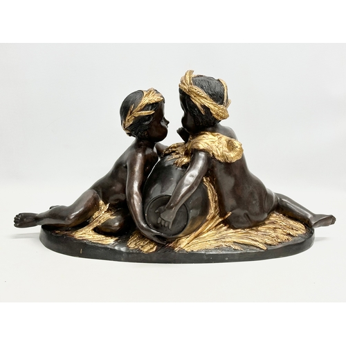 19 - A large signed Late 19th/Early 20th Century bronze sitting cherubs. Holding a gilded urn with rosett... 