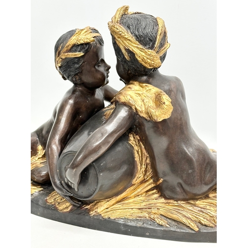 19 - A large signed Late 19th/Early 20th Century bronze sitting cherubs. Holding a gilded urn with rosett... 