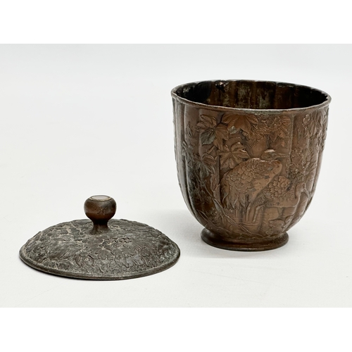 179 - A small Late 19th Century Japanese bronze pot with cover. With glass top handle, embossed wildflower... 