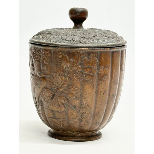 179 - A small Late 19th Century Japanese bronze pot with cover. With glass top handle, embossed wildflower... 