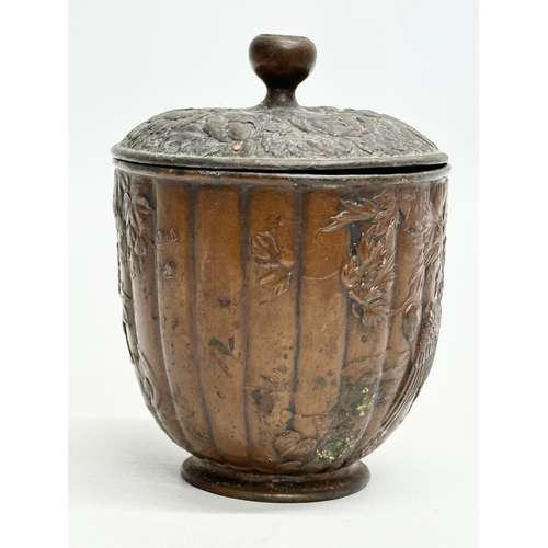 179 - A small Late 19th Century Japanese bronze pot with cover. With glass top handle, embossed wildflower... 