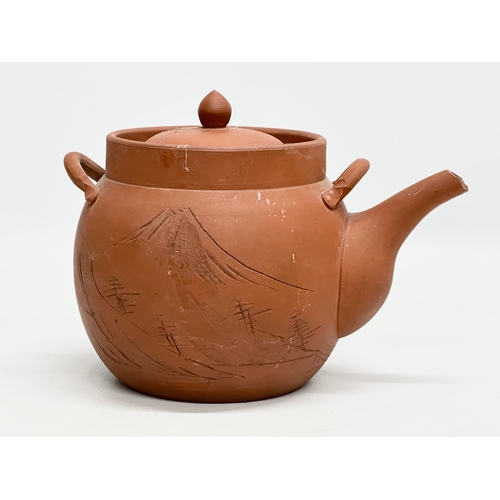 35 - A signed Early 20th Century Chinese Yixing teapot. Impressed mark. 22x14x16cm.