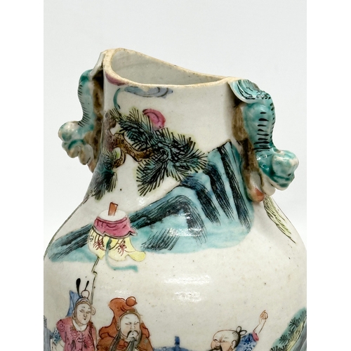 201 - A 19th Century Chinese Late Qing Dynasty vase. Decorated by 2 foo dog handles, god and immortals on ... 