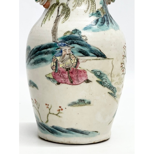 201 - A 19th Century Chinese Late Qing Dynasty vase. Decorated by 2 foo dog handles, god and immortals on ... 