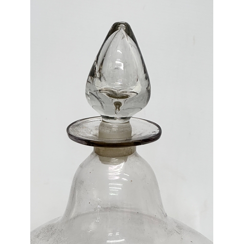 55 - A large Mid 19th Century glass apothecary chemist jar with stopper. 21x40cm