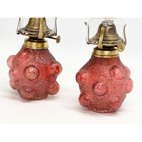 22 - A pair of Early 20th Century Kralik Humpen style salt glazed glass oil lamps. 29cm