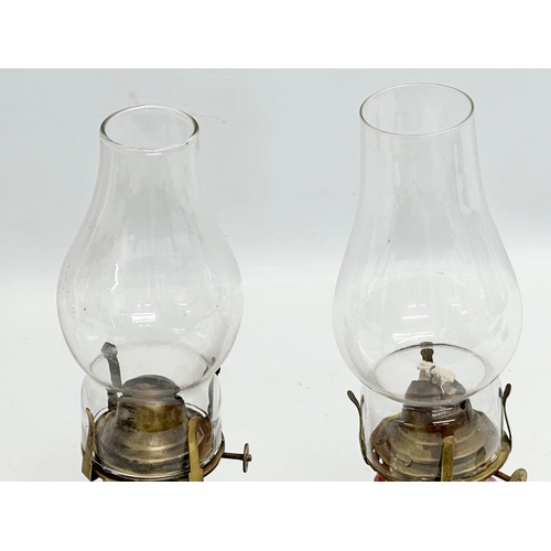 22 - A pair of Early 20th Century Kralik Humpen style salt glazed glass oil lamps. 29cm