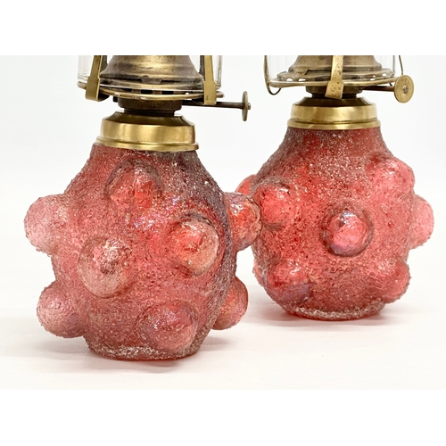 22 - A pair of Early 20th Century Kralik Humpen style salt glazed glass oil lamps. 29cm