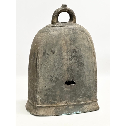 206 - A large 19th Century Burmese bronze bell. 23x14x36cm.