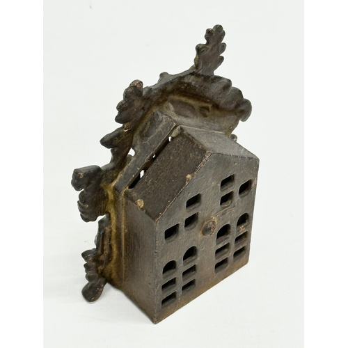 214 - A 19th Century Victorian cast iron “Bear and Honey” money box. 10x5x14cm.